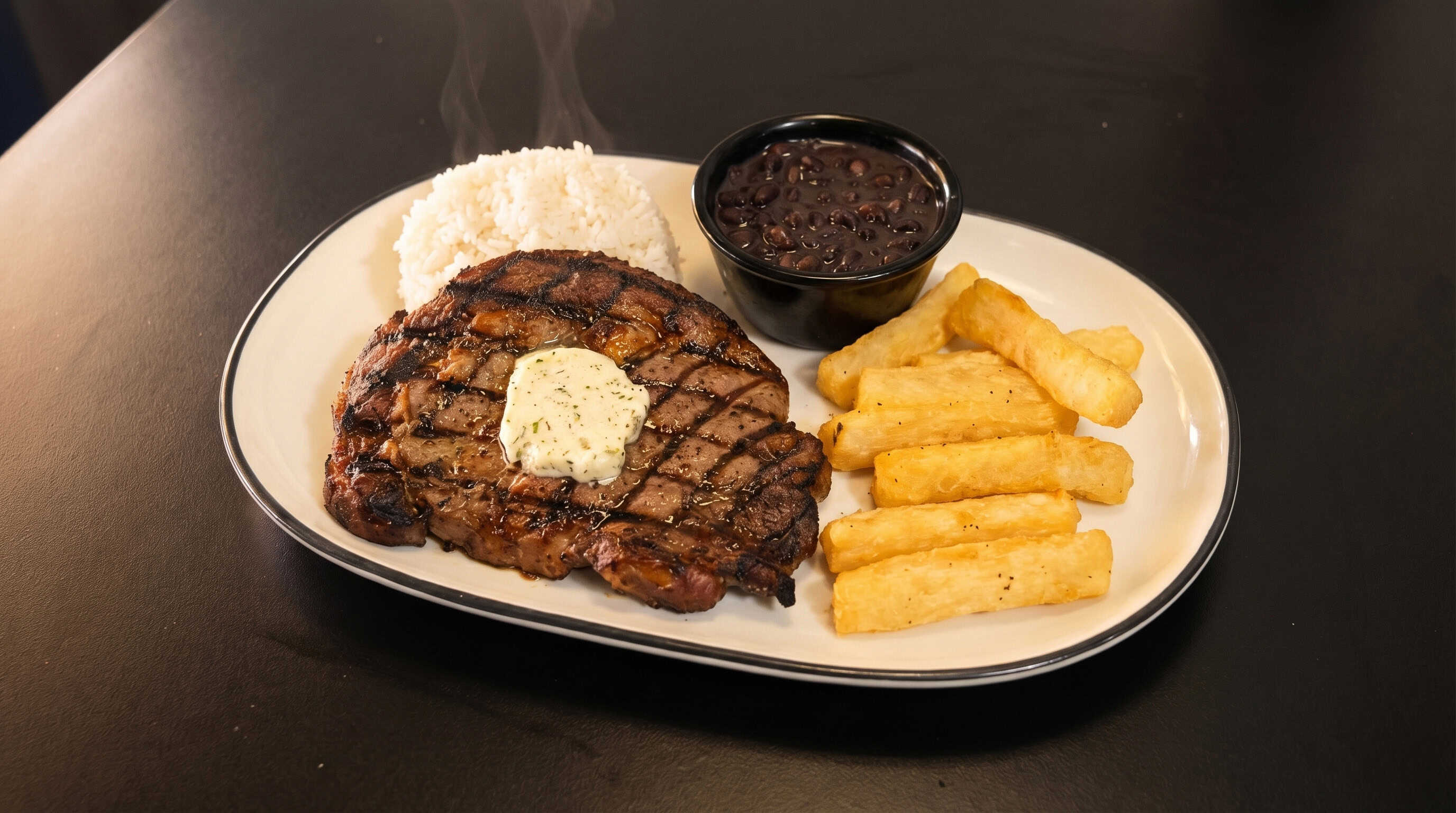 Grilled steak with yuca fries, white rice and black beans